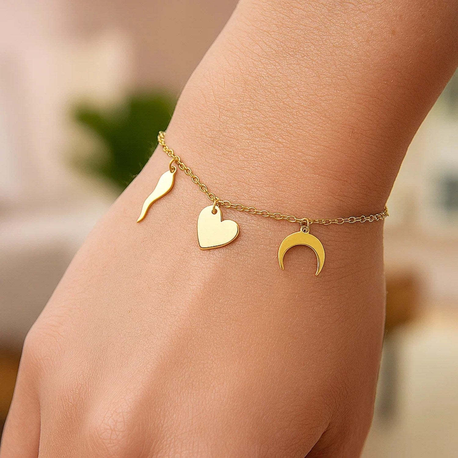 14k yellow gold 7-inch bracelet featuring polished charms in a modern chain design, perfect for elegant layering.