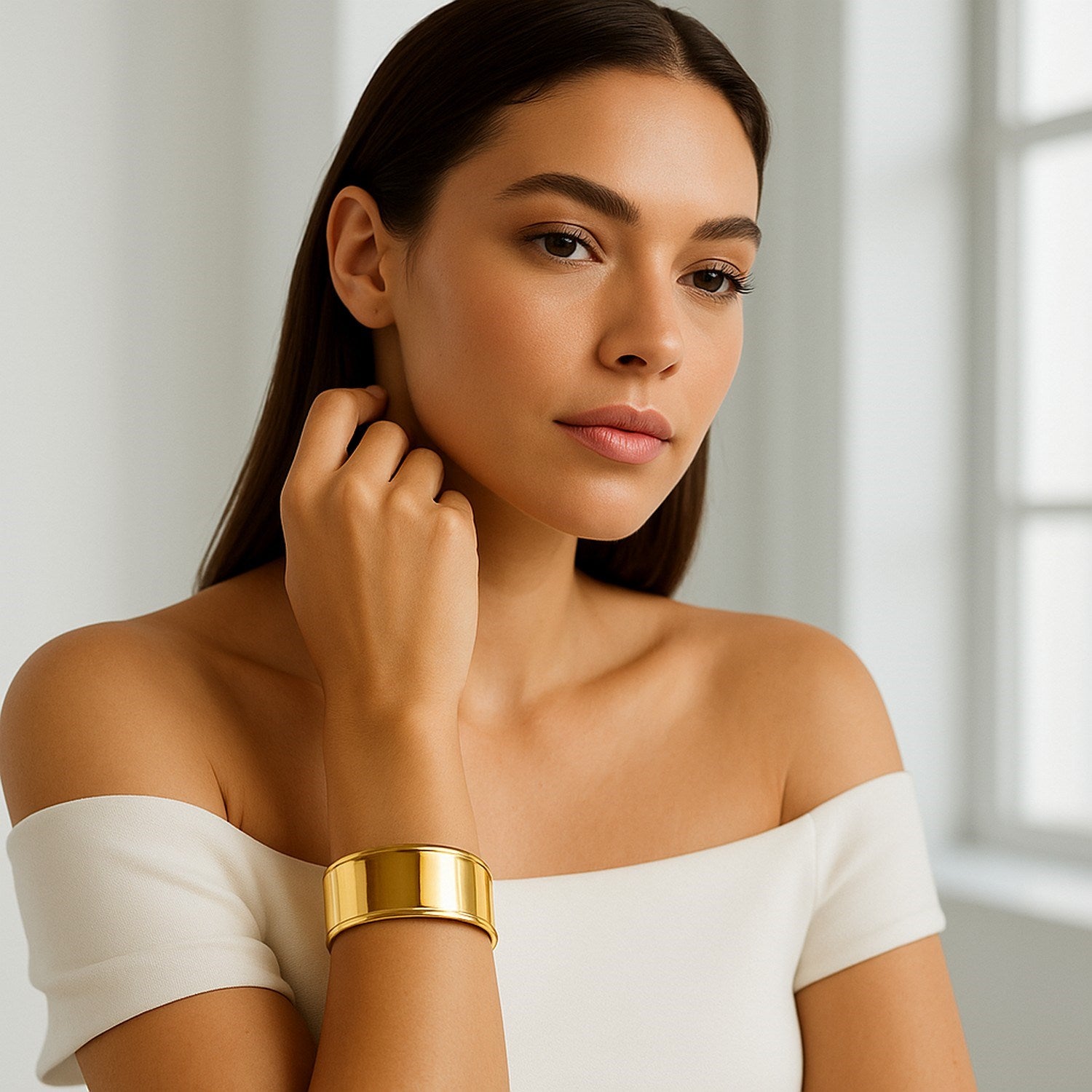 Modern 14k yellow gold cuff bangle with stud detail, showcasing elegant simplicity and timeless luxury.