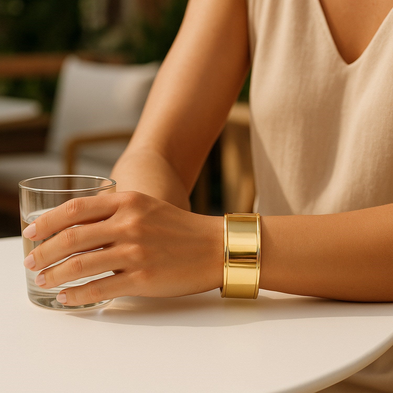 Classic 14k yellow gold cuff bangle with modern stud design, showcasing elegance and timeless luxury.