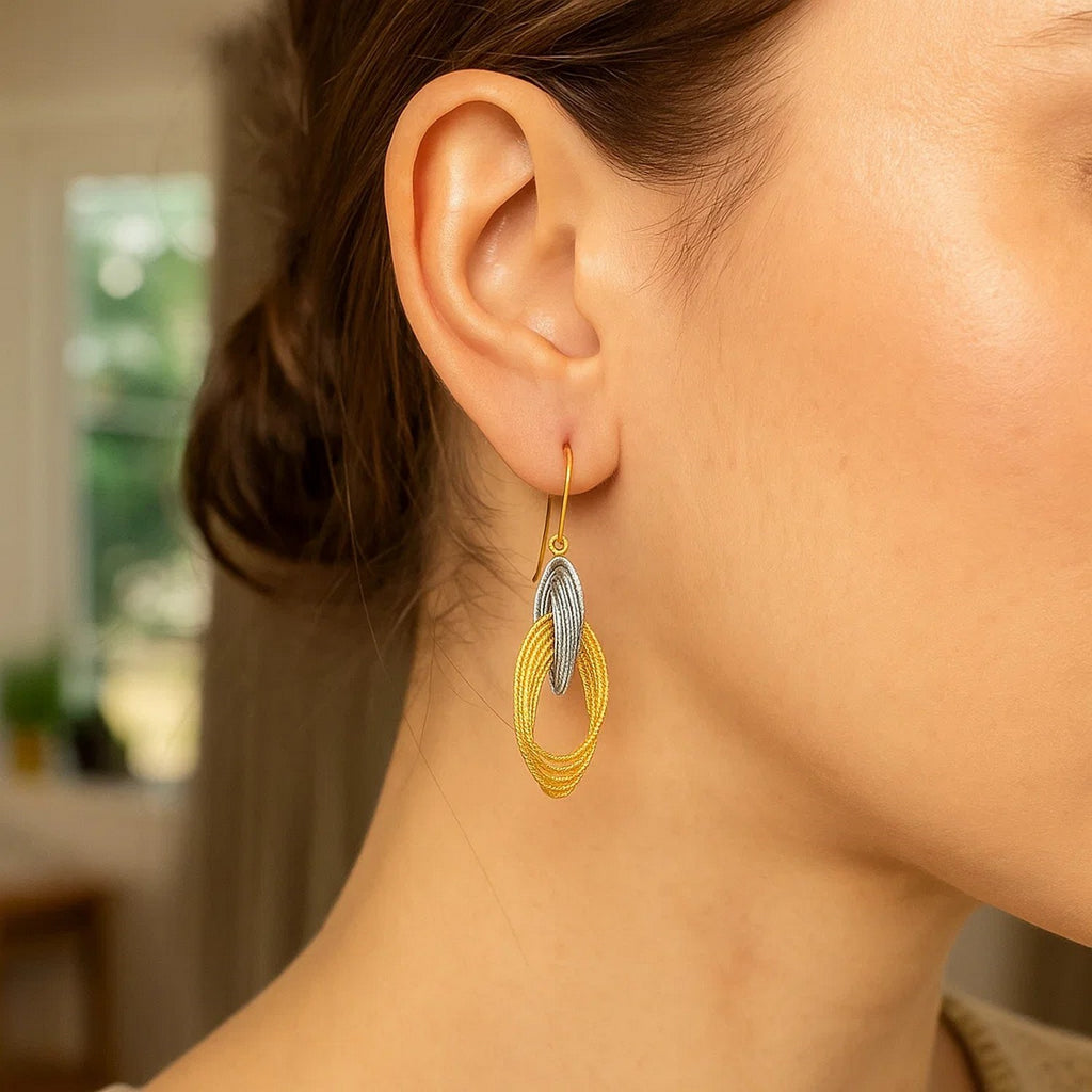 14k two-tone gold interlaced dangle earrings with modern design and elegant movement, perfect for any occasion.