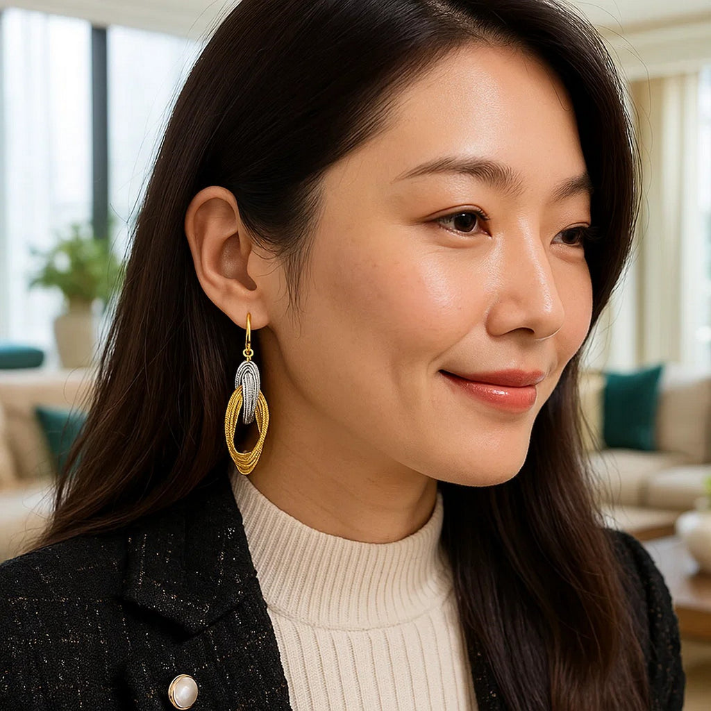 14k two-tone gold interlaced dangle earrings showcasing modern elegance and intricate design.