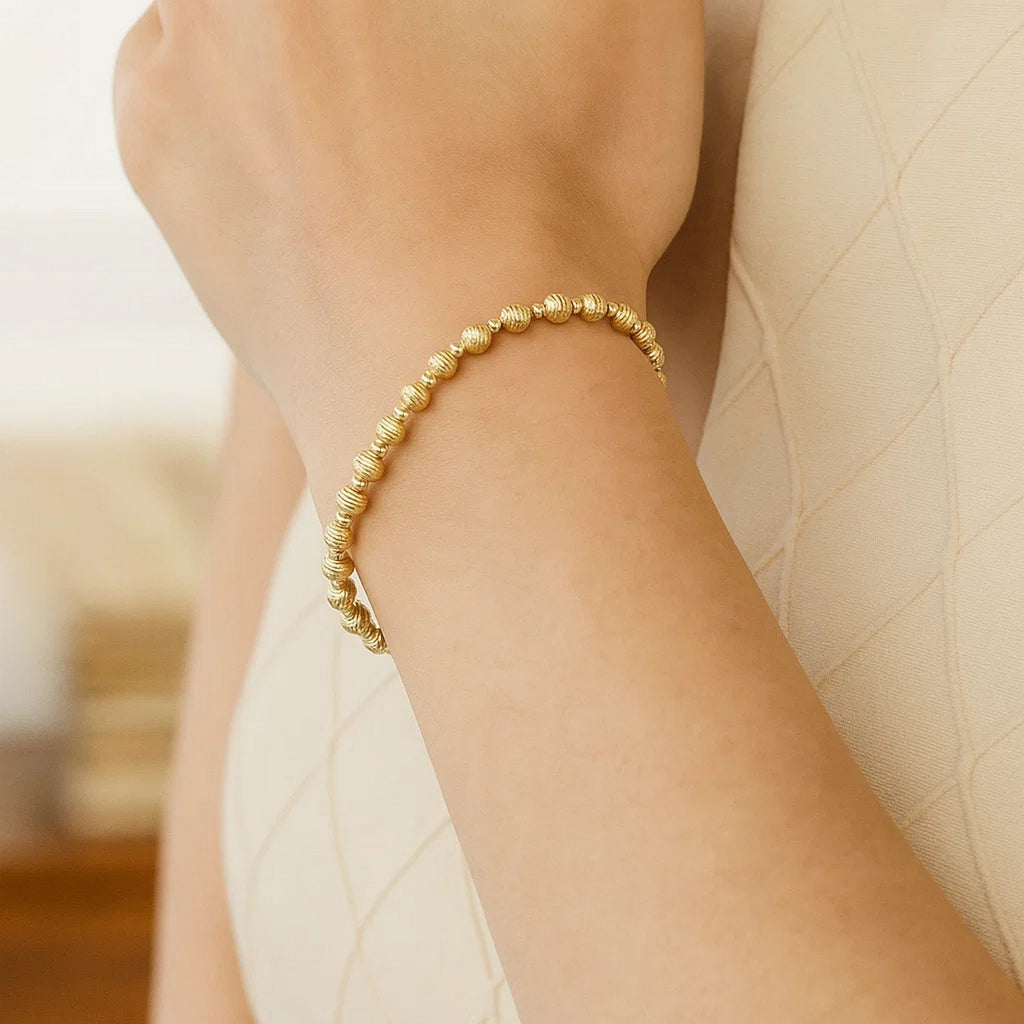 14K yellow gold disco diamond cut bead bracelet, elegantly designed with shimmering diamond accents for a luxurious touch.