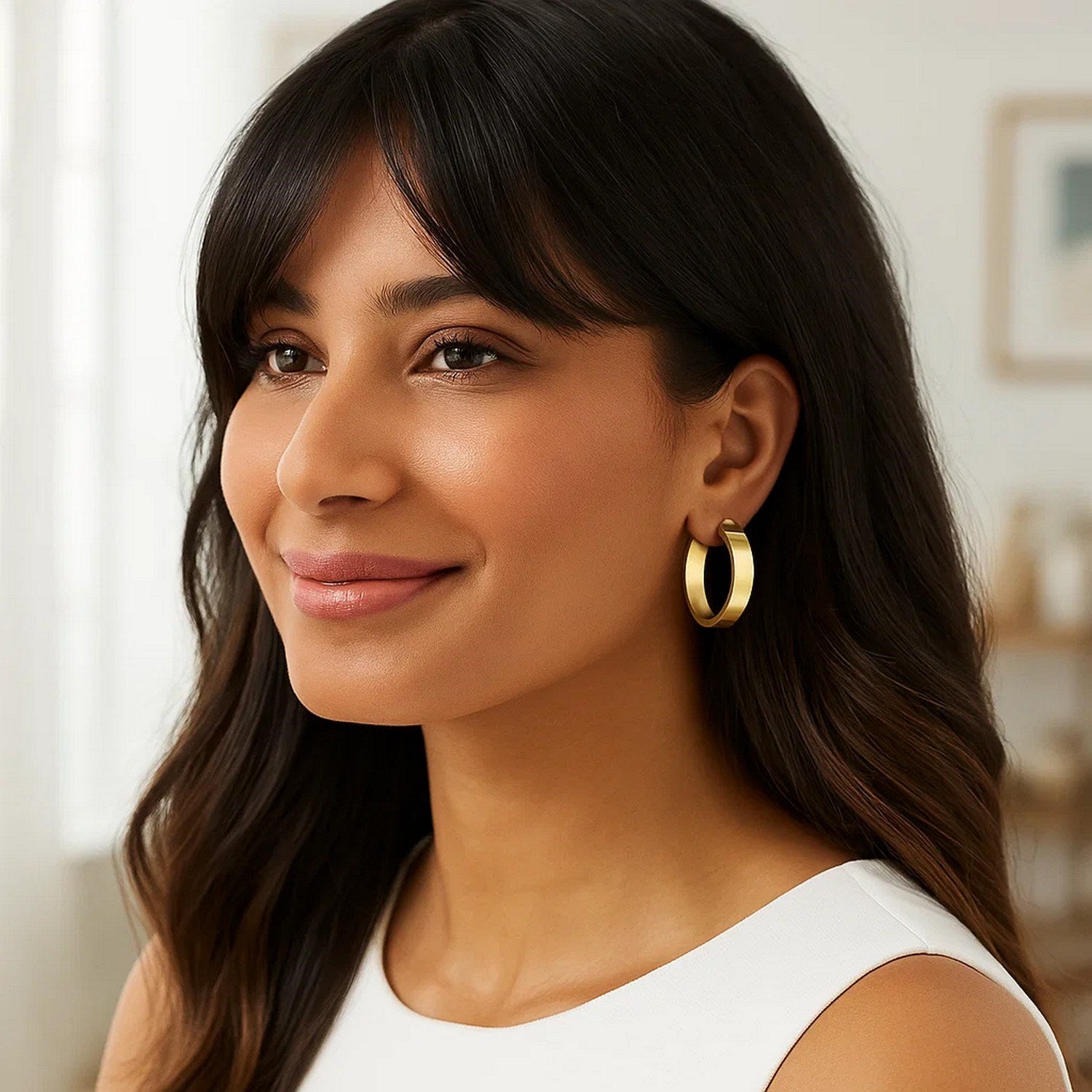 14K yellow gold medium tube-shaped hoop earrings with a modern design, perfect for elegant everyday wear.