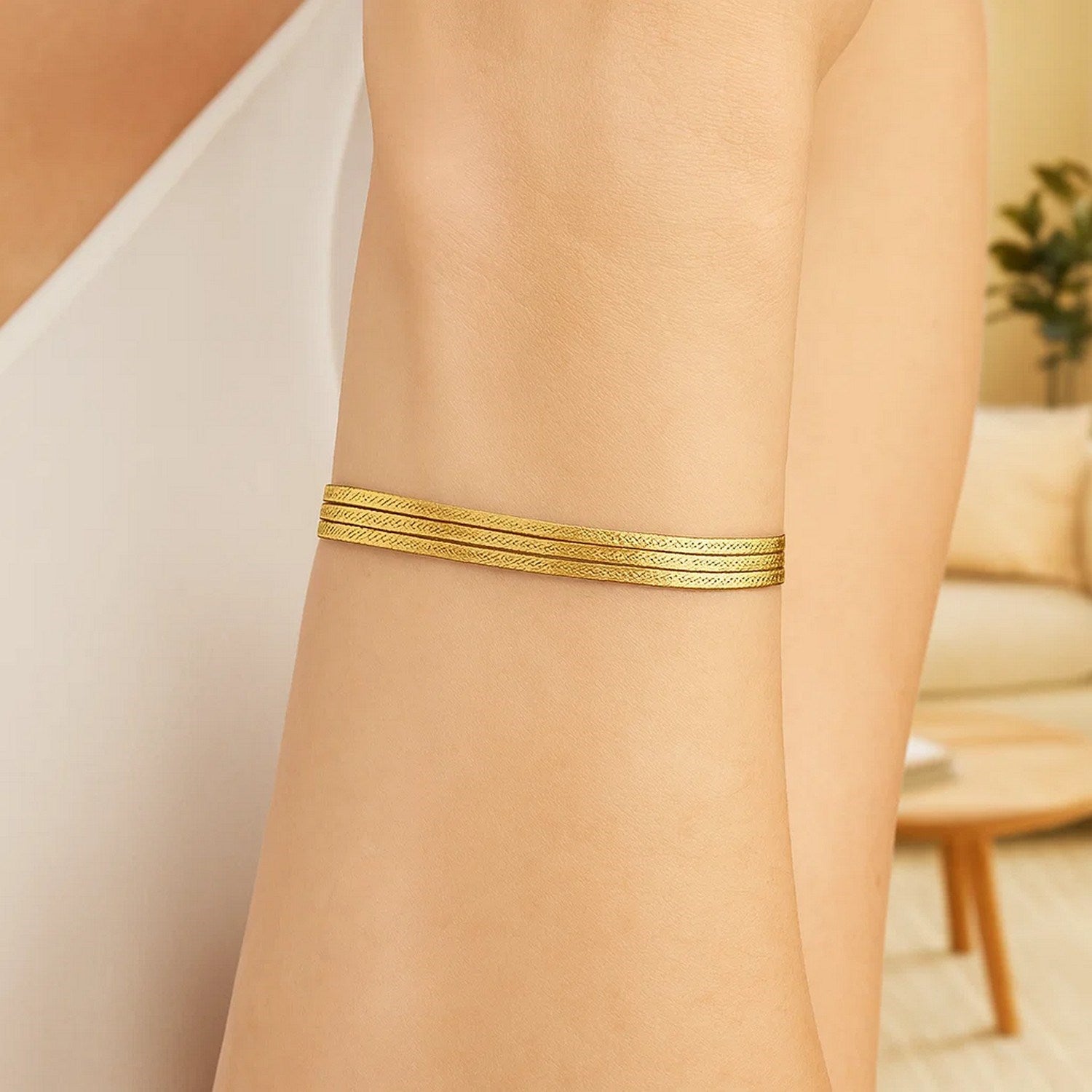 14k yellow gold three-strand herringbone chain bracelet, elegant design, 7 inches, perfect for sophisticated styling.