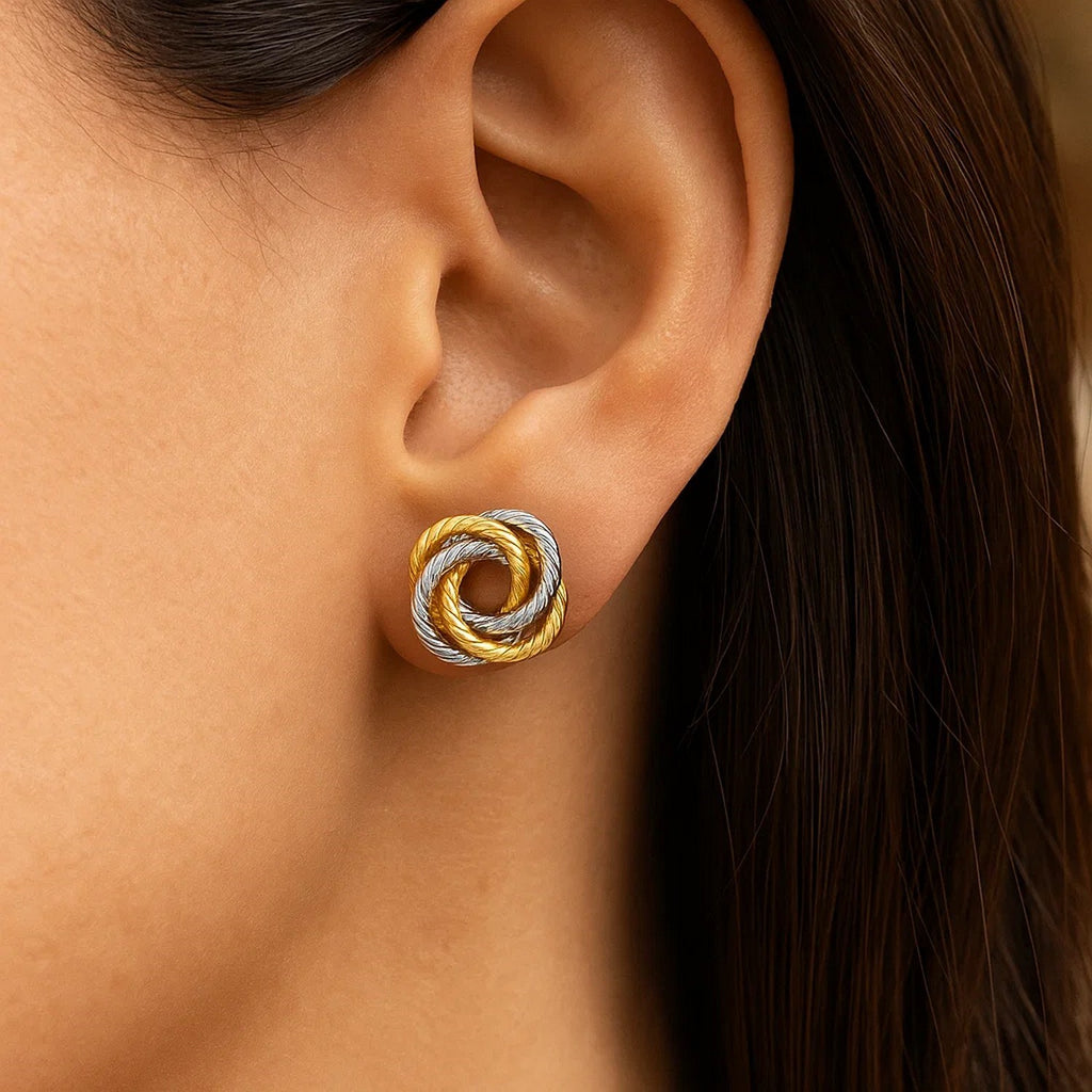 14k two-tone gold textured love knot earrings exuding elegance and luxury, perfect for any sophisticated occasion.