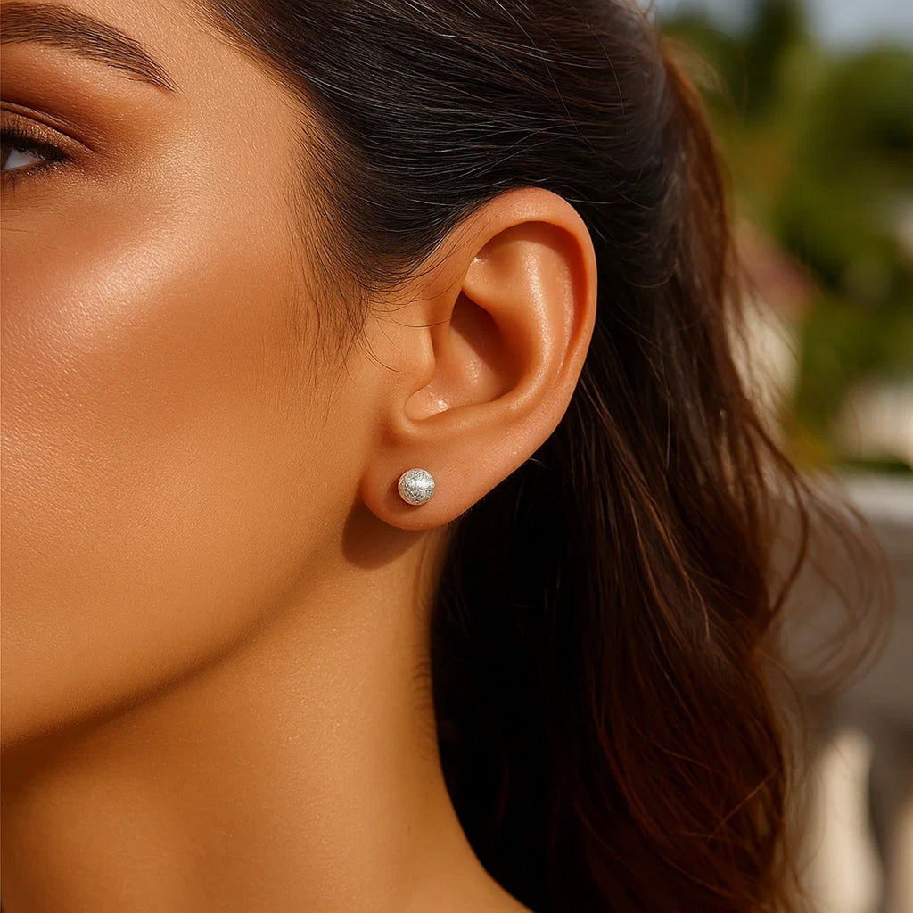 Elegant 14k white gold textured ball stud earrings showcasing a refined design for timeless luxury.