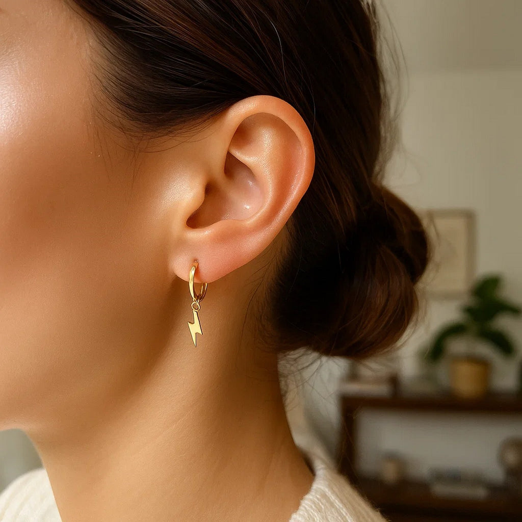 14k yellow gold modern lightning bolt drop hoop earrings with a sleek, contemporary design for a striking look.