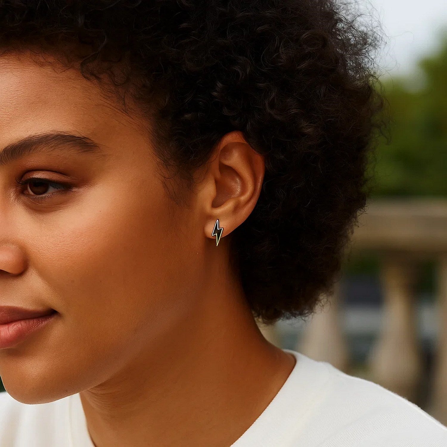 14k yellow gold stud earrings featuring modern black enamel lightning bolt design for a striking luxury statement.