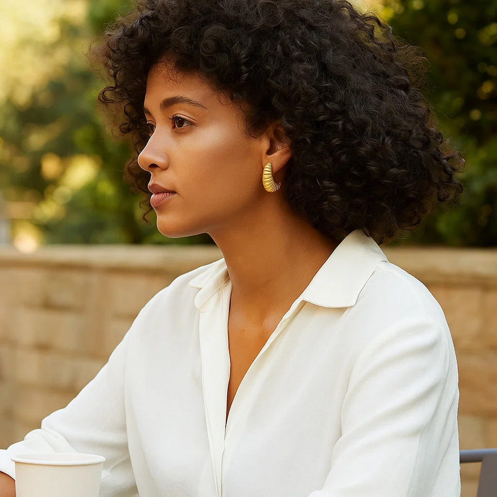 14k yellow gold polished hoop earrings with a contemporary design, showcasing elegance and timeless sophistication.