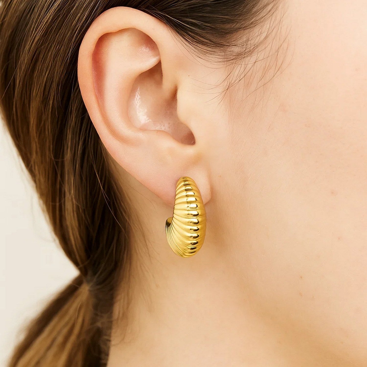 Contemporary 14k yellow gold polished hoop earrings showcasing a sleek, elegant design for a luxurious touch.