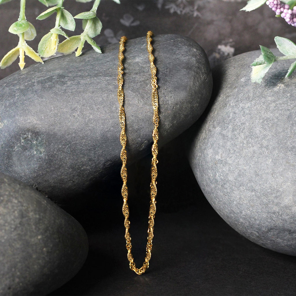 Elegant 14k yellow gold Singapore chain, 1.80 mm, showcasing a refined design perfect for layering or standalone wear.