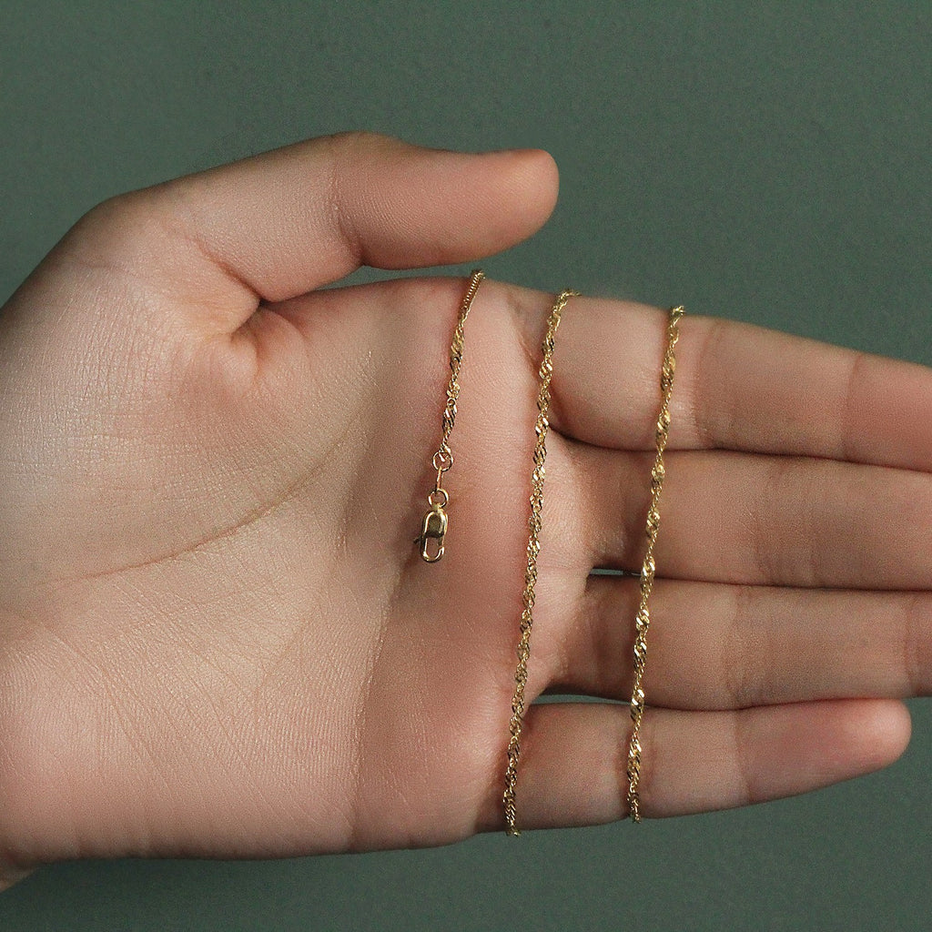 Elegant 14k yellow gold Singapore chain, 1.80 mm, showcasing a refined and luxurious design for sophisticated style.