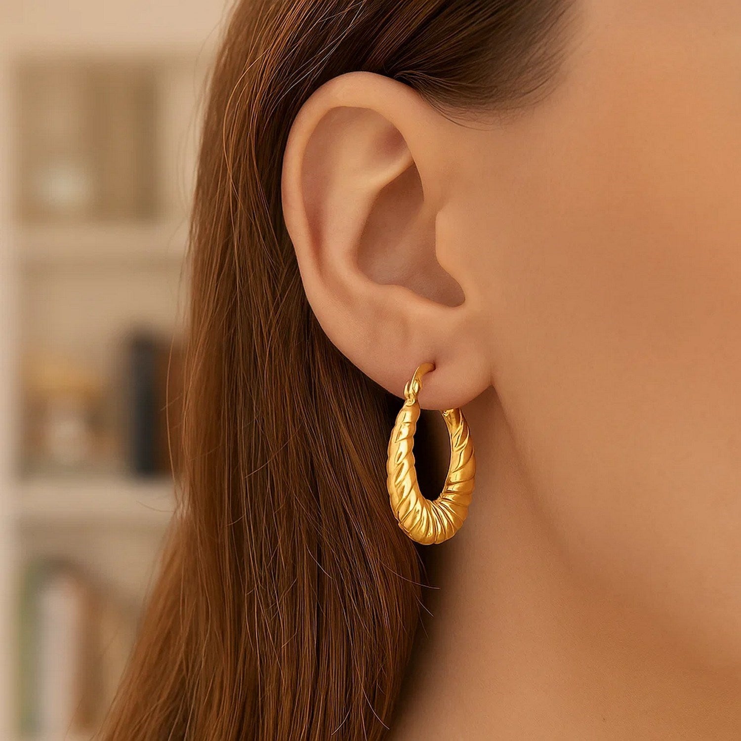 14k yellow gold polished twisted hoop earrings, showcasing modern elegance and exquisite craftsmanship.