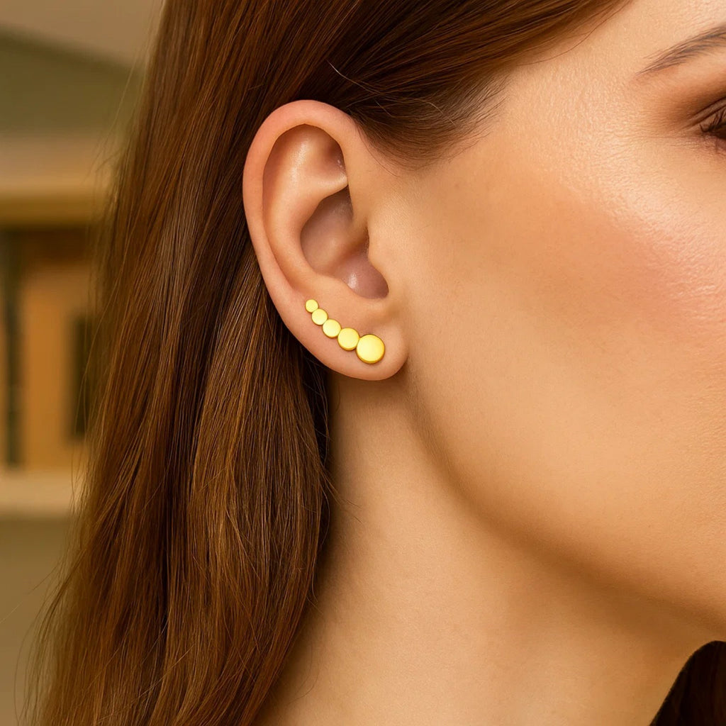 14k yellow gold graduated circles climber earrings with a modern design, perfect for a luxurious statement look.