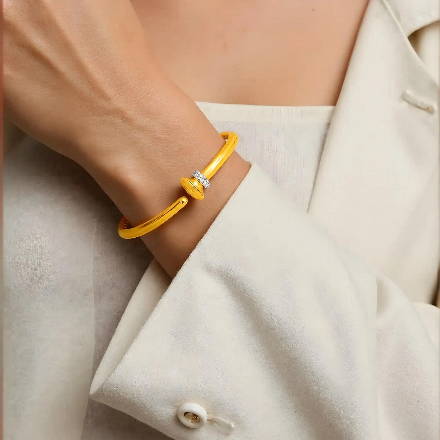 14k yellow gold hinged bangle bracelet adorned with sparkling diamonds, showcasing a modern luxury design.