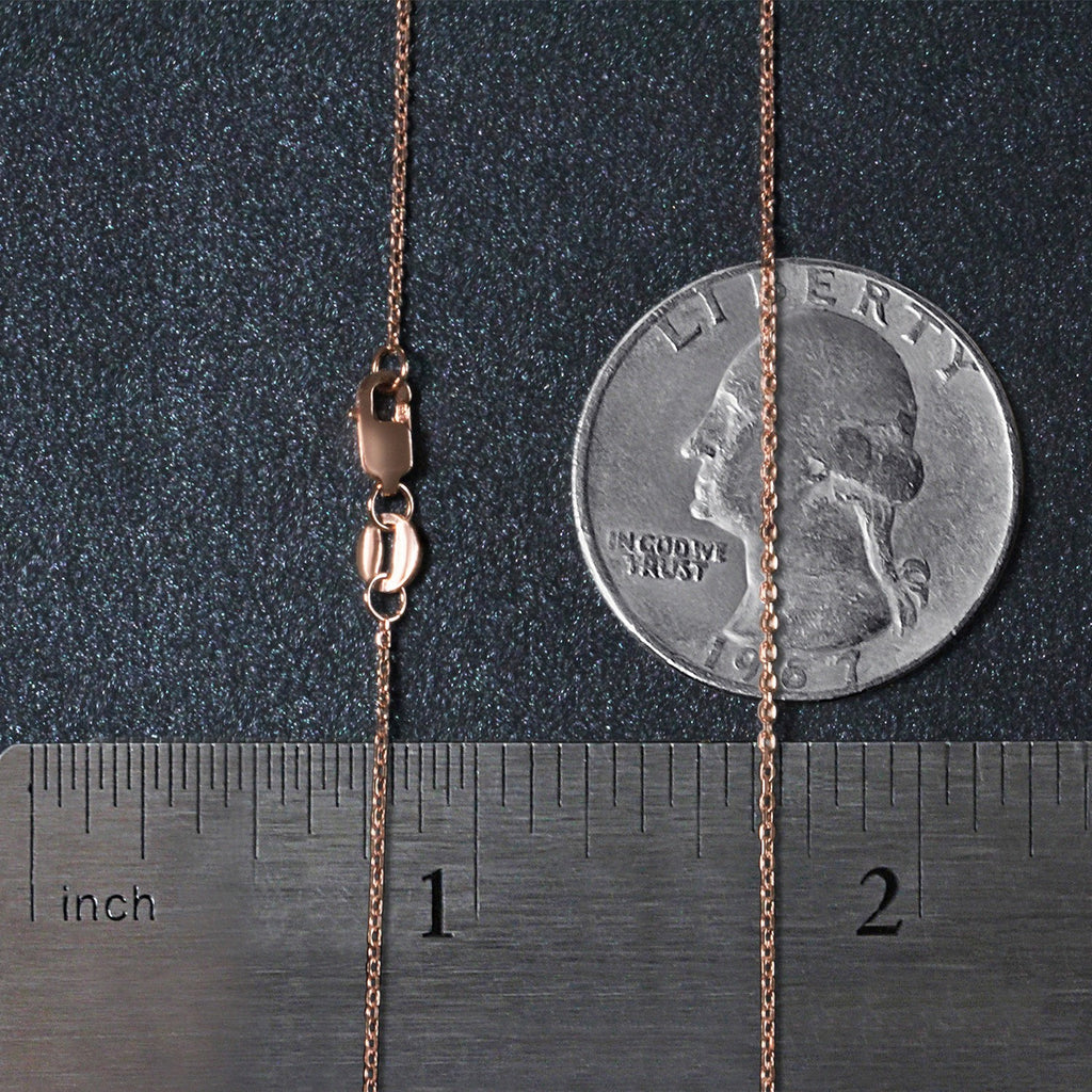 Rose gold diamond cut cable link chain, modern design, featuring delicate links and luxurious shine, perfect for layering.