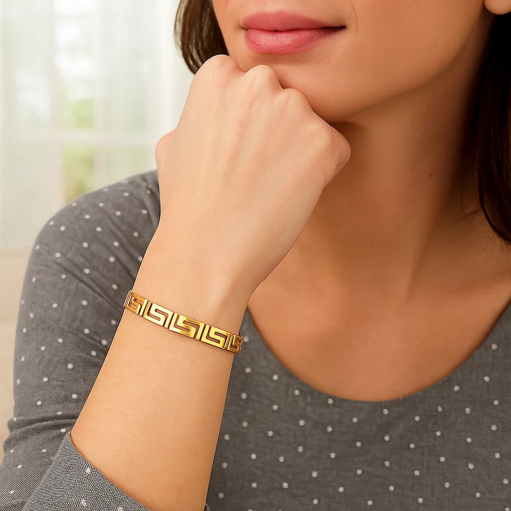 Elegant 14k yellow gold bracelet featuring a sophisticated Greek key motif and delicate chain design.