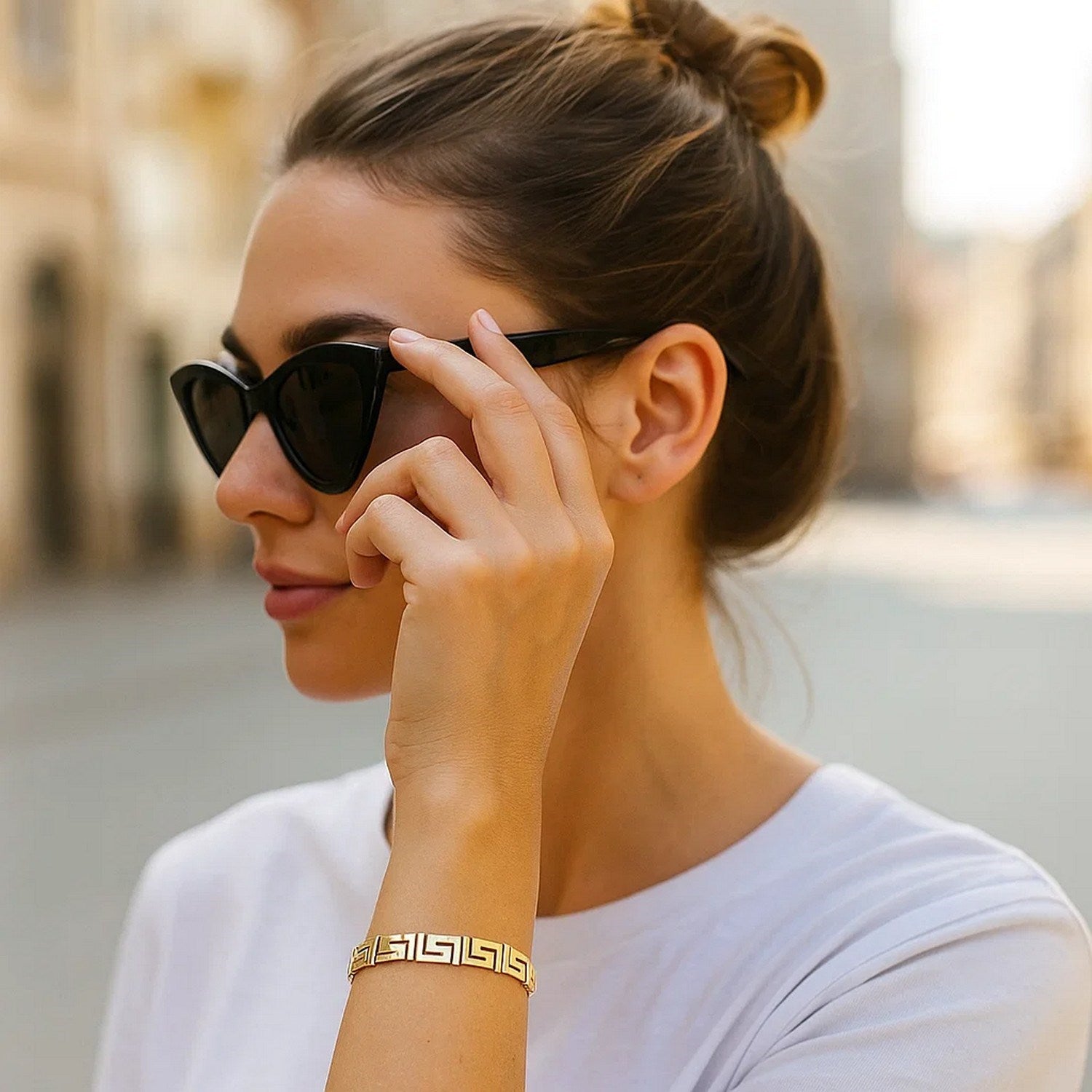Elegant 14k yellow gold bracelet featuring a fancy Greek key motif and a delicate chain design.