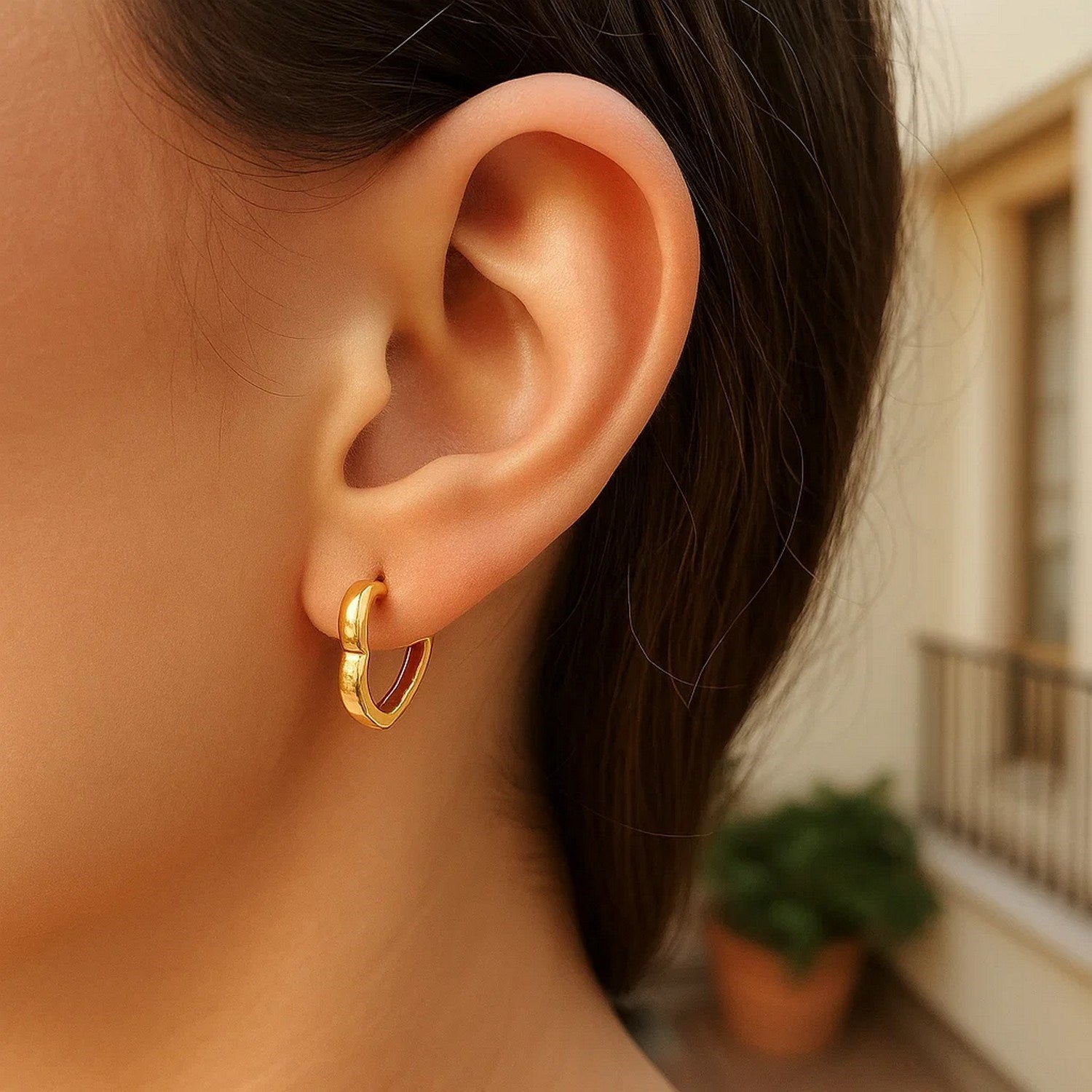14k yellow gold heart huggie hoop earrings, elegantly crafted for a classic and timeless look.