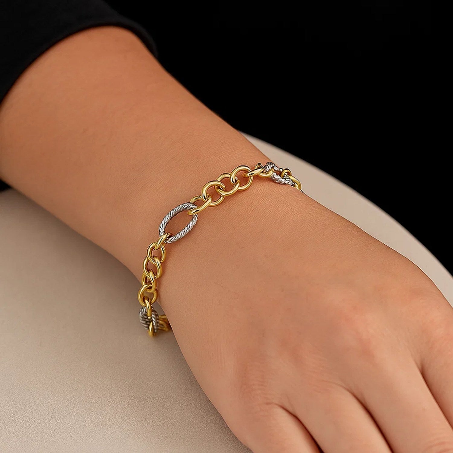 14k two-tone gold rope motif bracelet featuring oval and round links, exuding timeless elegance and luxury.
