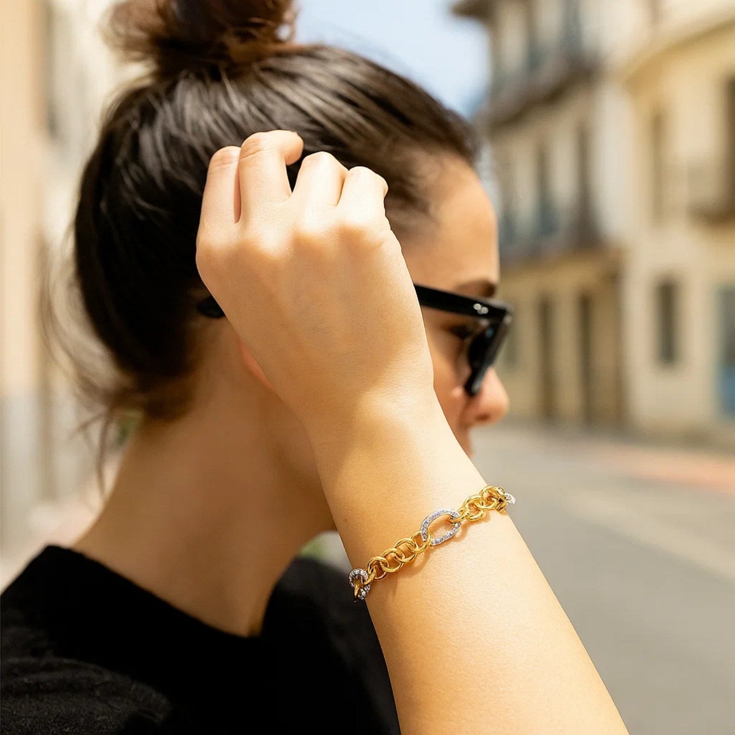 14k two-tone gold rope motif bracelet featuring oval and round links, exuding classic elegance and luxury.