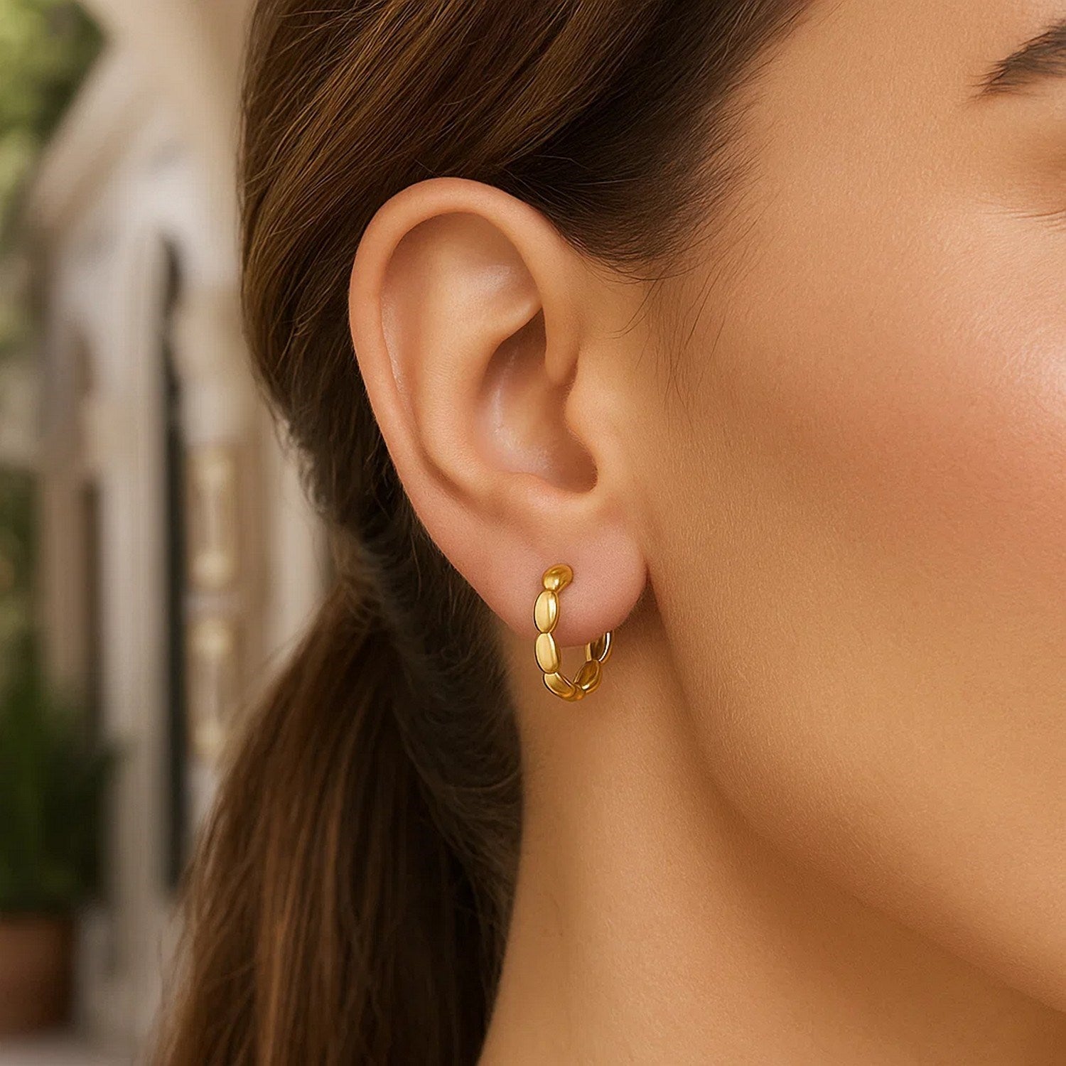 14k yellow gold medium rice hoop earrings showcasing a modern design with elegant curvature and polished finish.