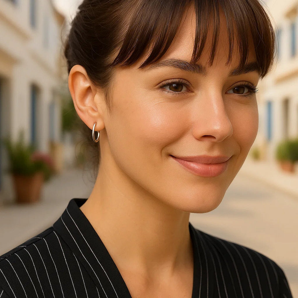 Polished sterling silver rhodium plated hoop earrings with an elegant design, perfect for sophisticated occasions.