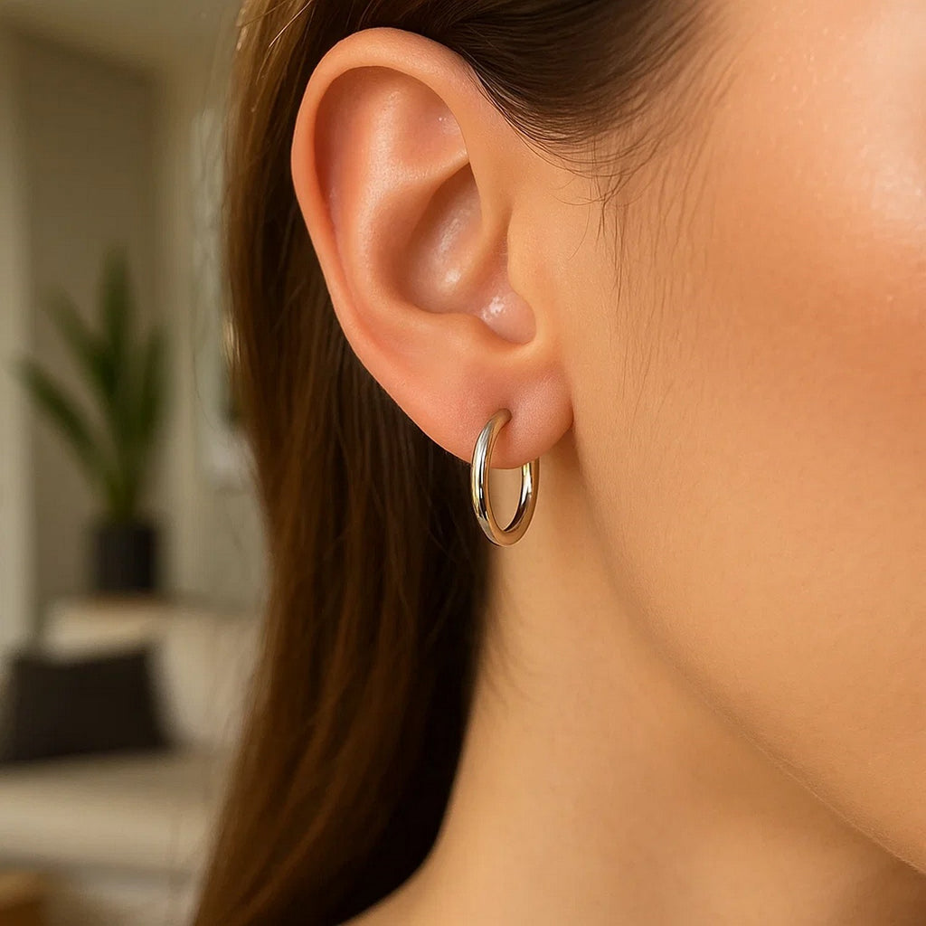 Polished sterling silver rhodium plated hoop earrings with an elegant design, perfect for sophisticated occasions.