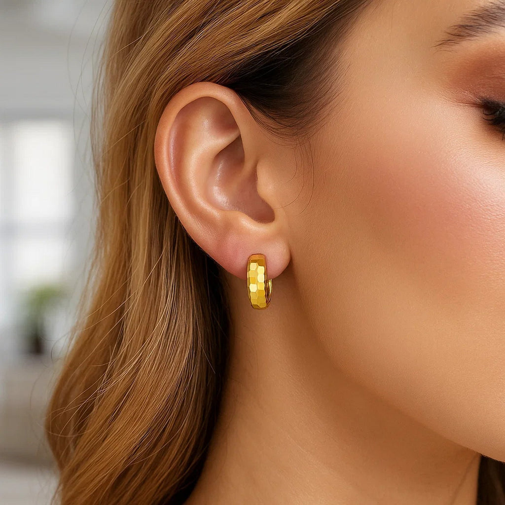 14K yellow gold polished huggie hoop earrings with a sleek modern design, perfect for elegant everyday wear.