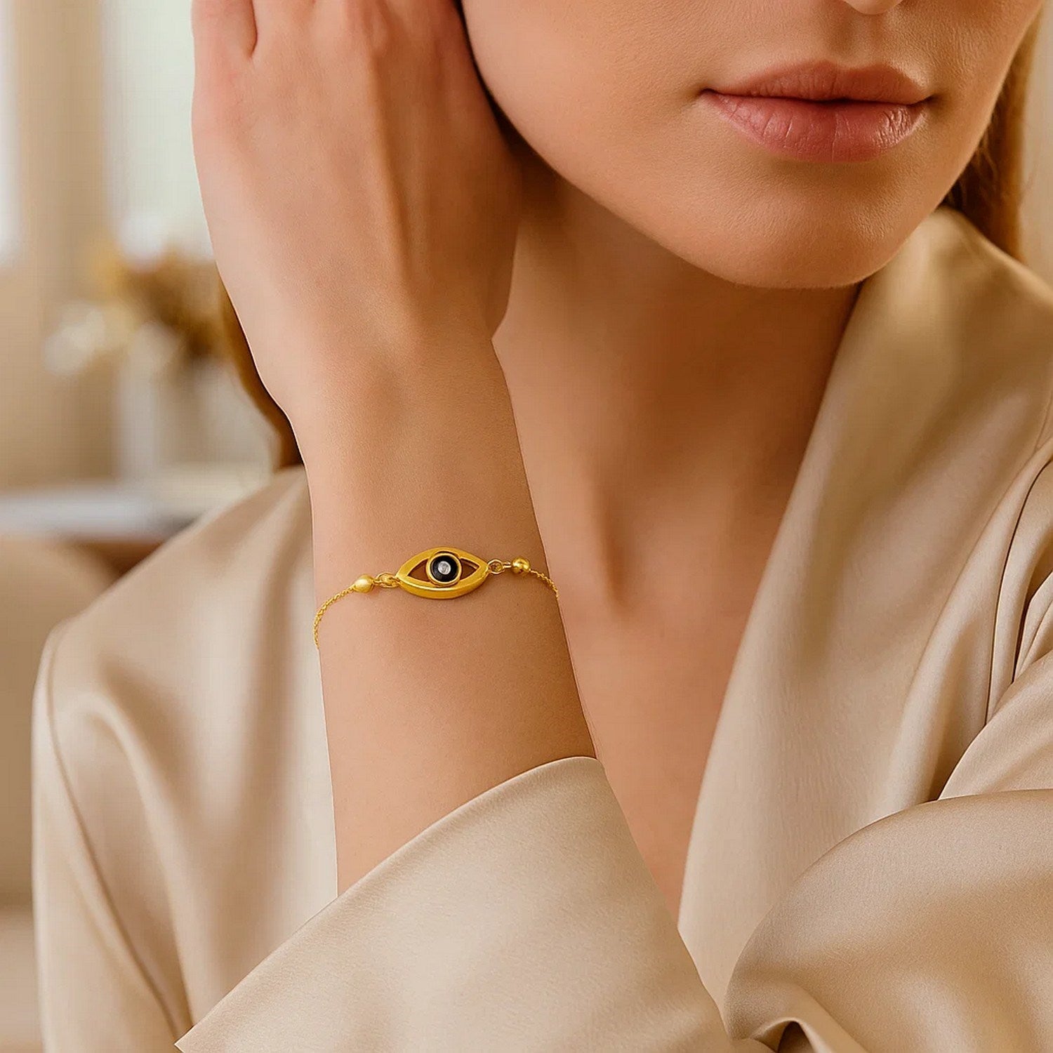Elegant 14k yellow gold adjustable bracelet featuring a delicate evil eye design on a refined chain.