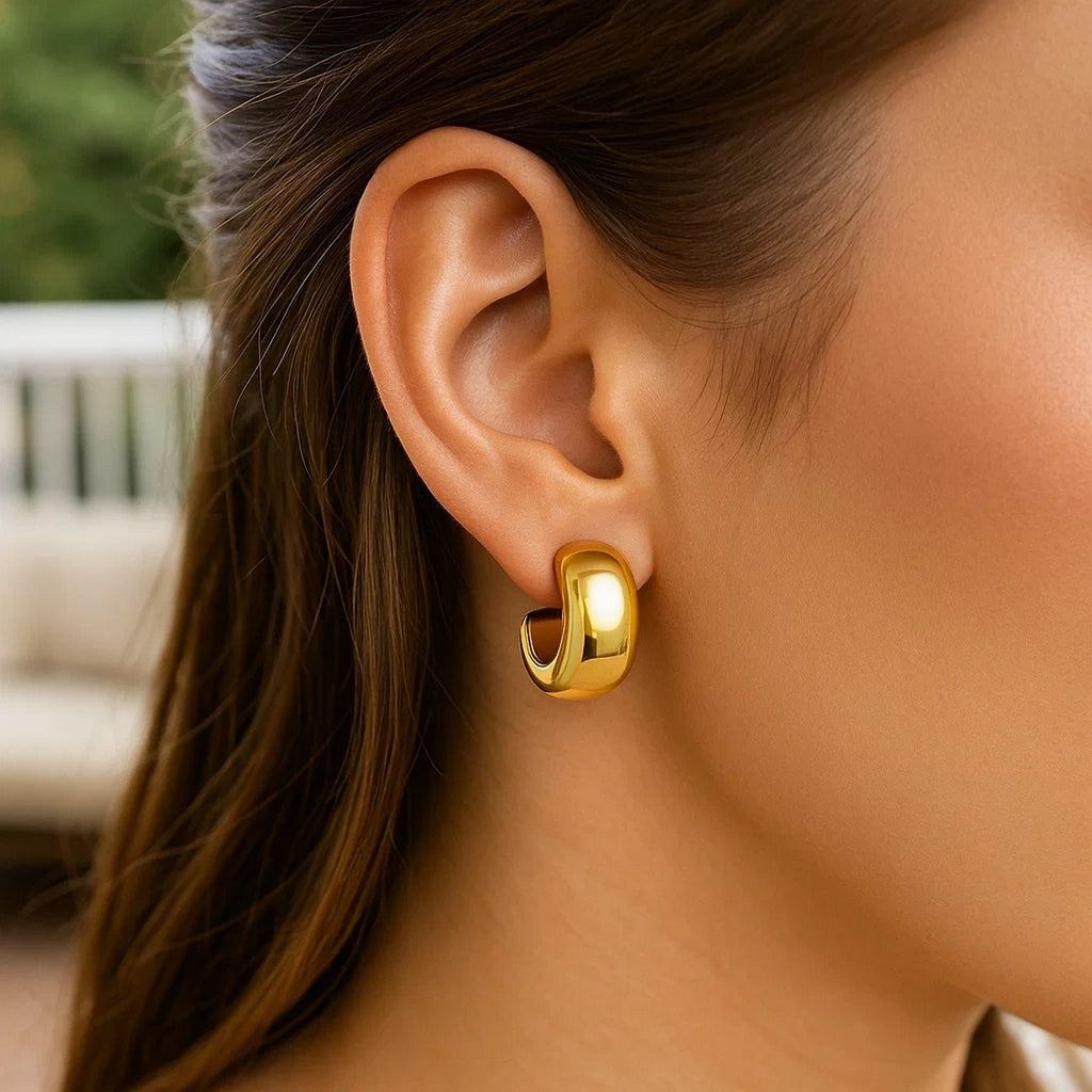 14K yellow gold polished hoop huggie earrings with a sleek modern design, perfect for elegant everyday wear.