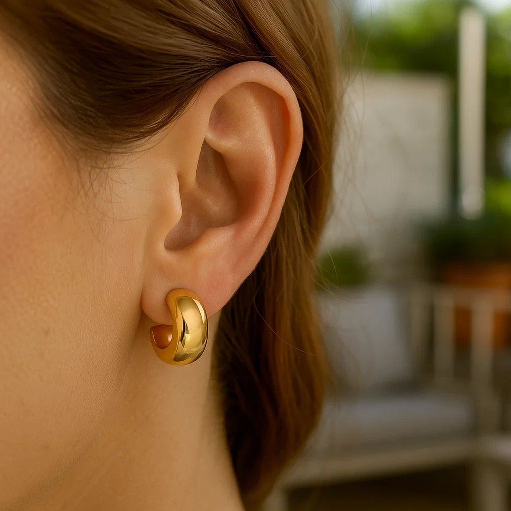 14k yellow gold polished hoop huggie earrings with a sleek, modern design for elegant everyday wear.