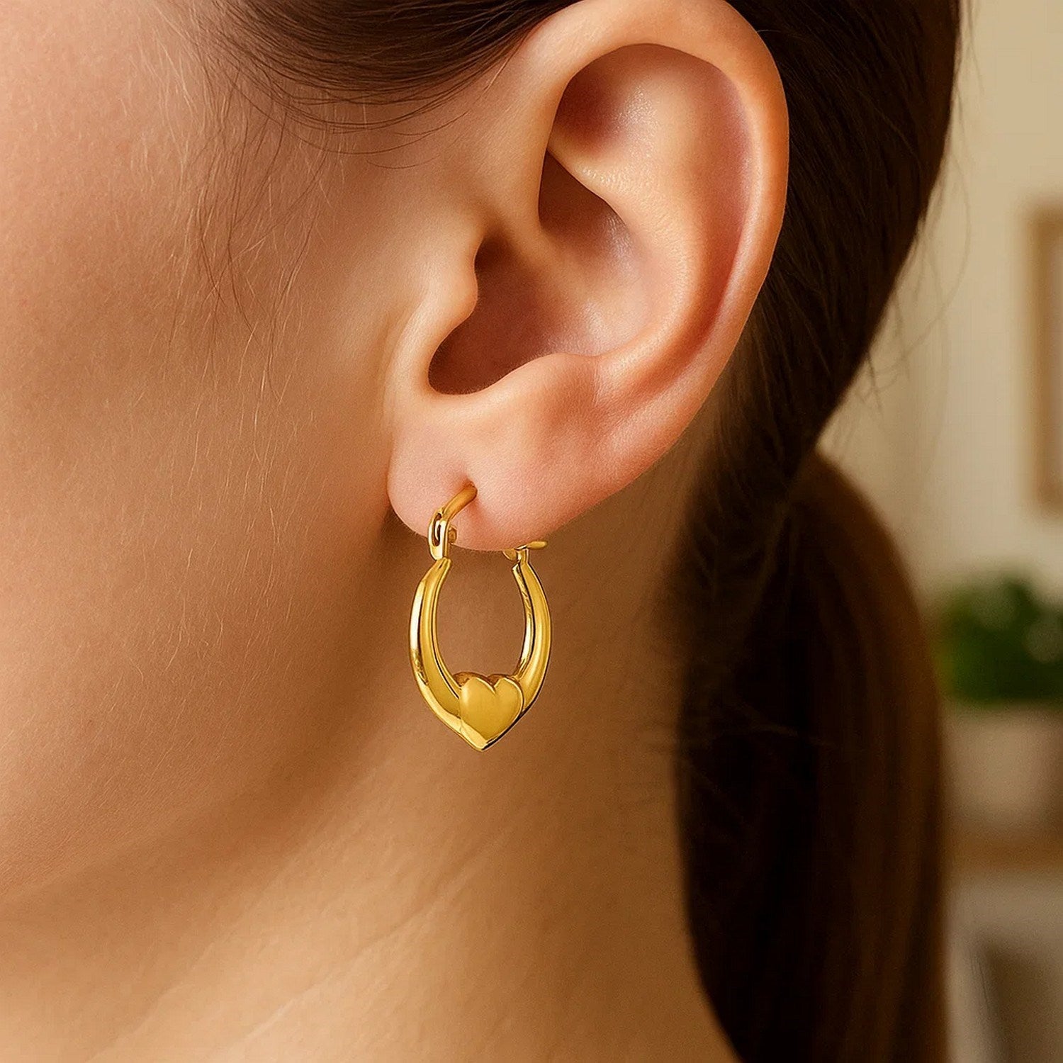 14k yellow gold small heart hoop earrings with a contemporary design, perfect for elegant everyday wear.