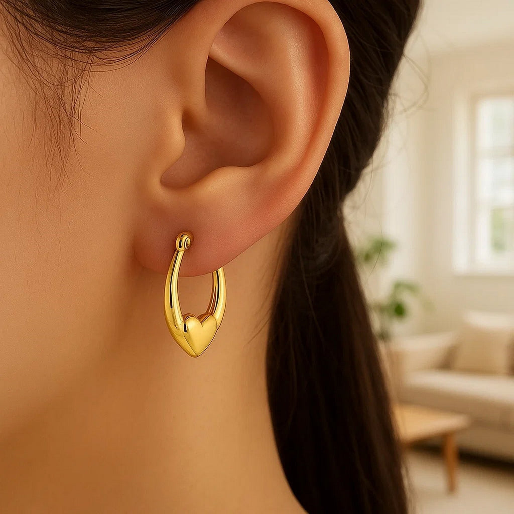 14k yellow gold small heart hoop earrings with a contemporary design, perfect for elegant everyday wear.