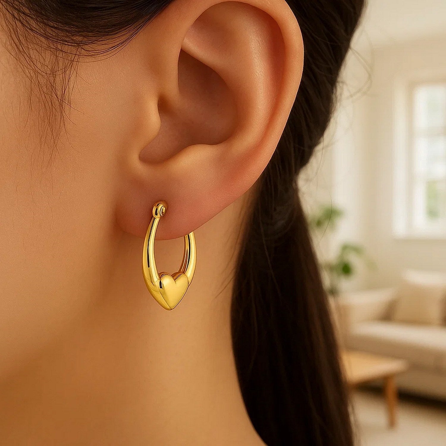 14k yellow gold small heart hoop earrings with a contemporary design, perfect for elegant everyday wear.