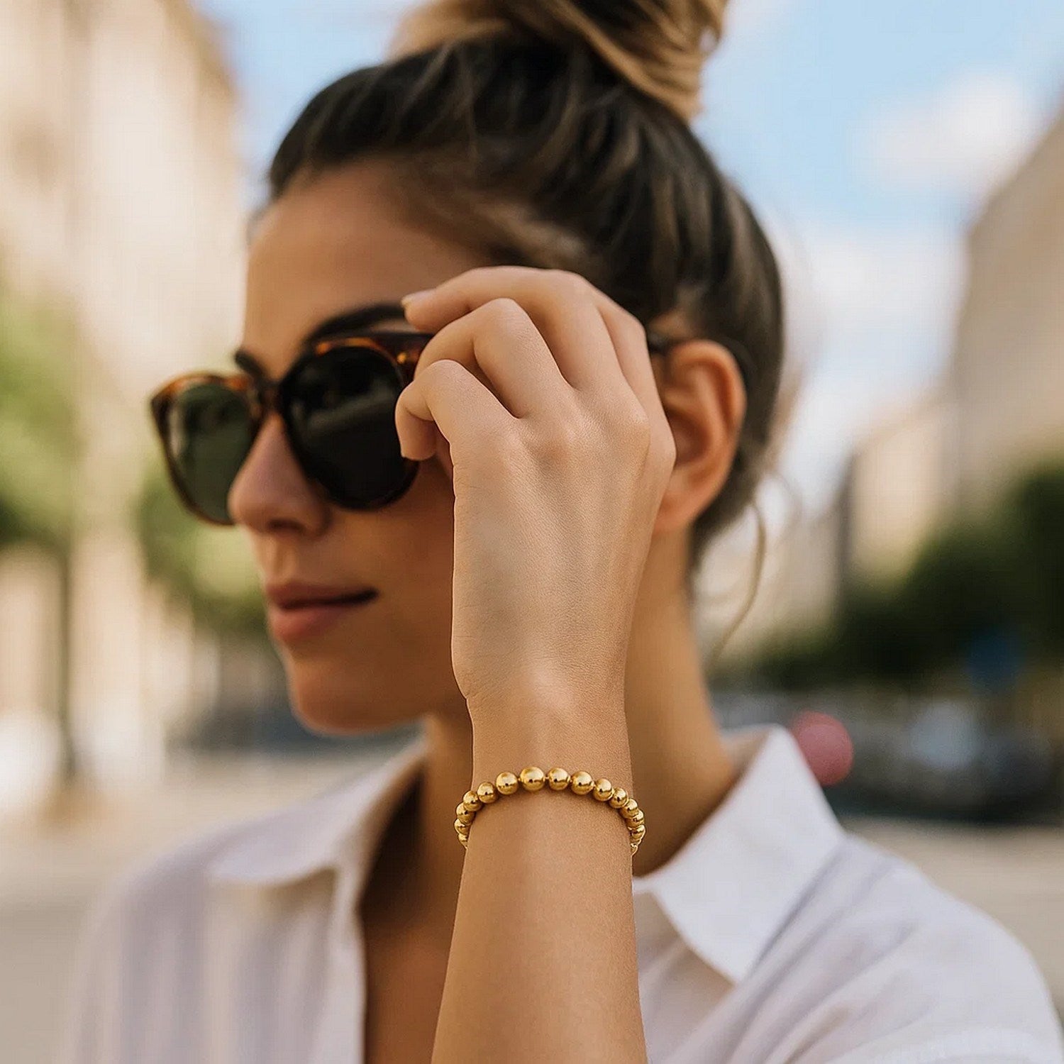 Polished 7mm bead bracelet in luxurious 14k yellow gold, showcasing minimalist elegance and timeless sophistication.