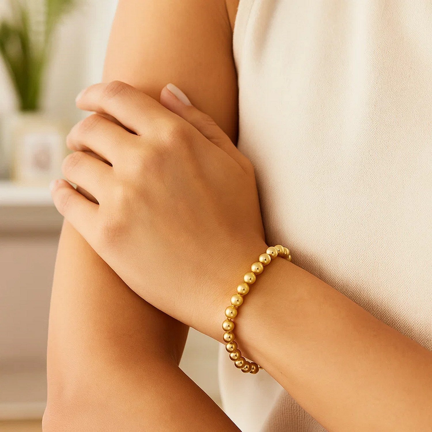 Polished 7mm bead bracelet in luxurious 14k yellow gold, featuring a minimalist design for elegant sophistication.