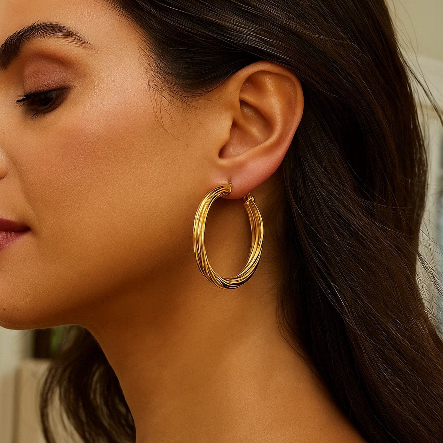 14k yellow gold textured large hoop earrings showcasing modern elegance and exquisite craftsmanship.