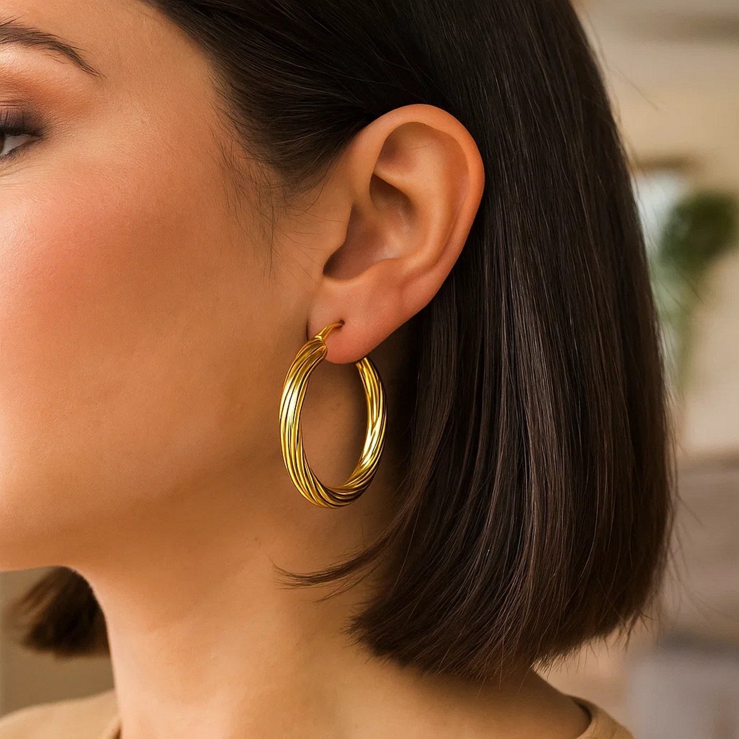 14k yellow gold textured large hoop earrings showcasing a modern design with exquisite craftsmanship and elegance.