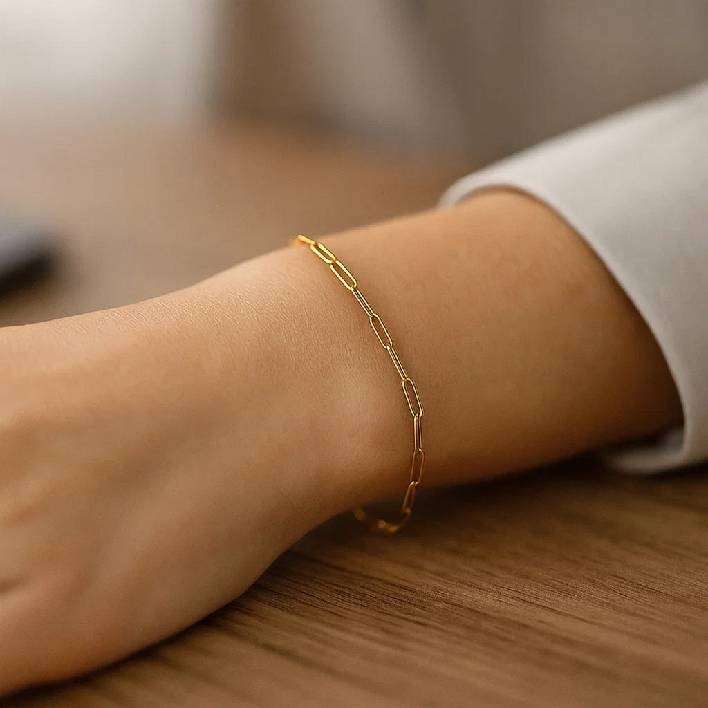 14k yellow gold paperclip bracelet featuring modern links and stud accents, perfect for elegant layering.