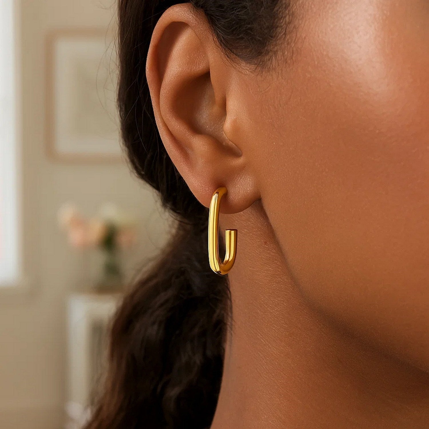 14k yellow gold polished hoop earrings with a sleek modern design, perfect for elegant everyday wear.
