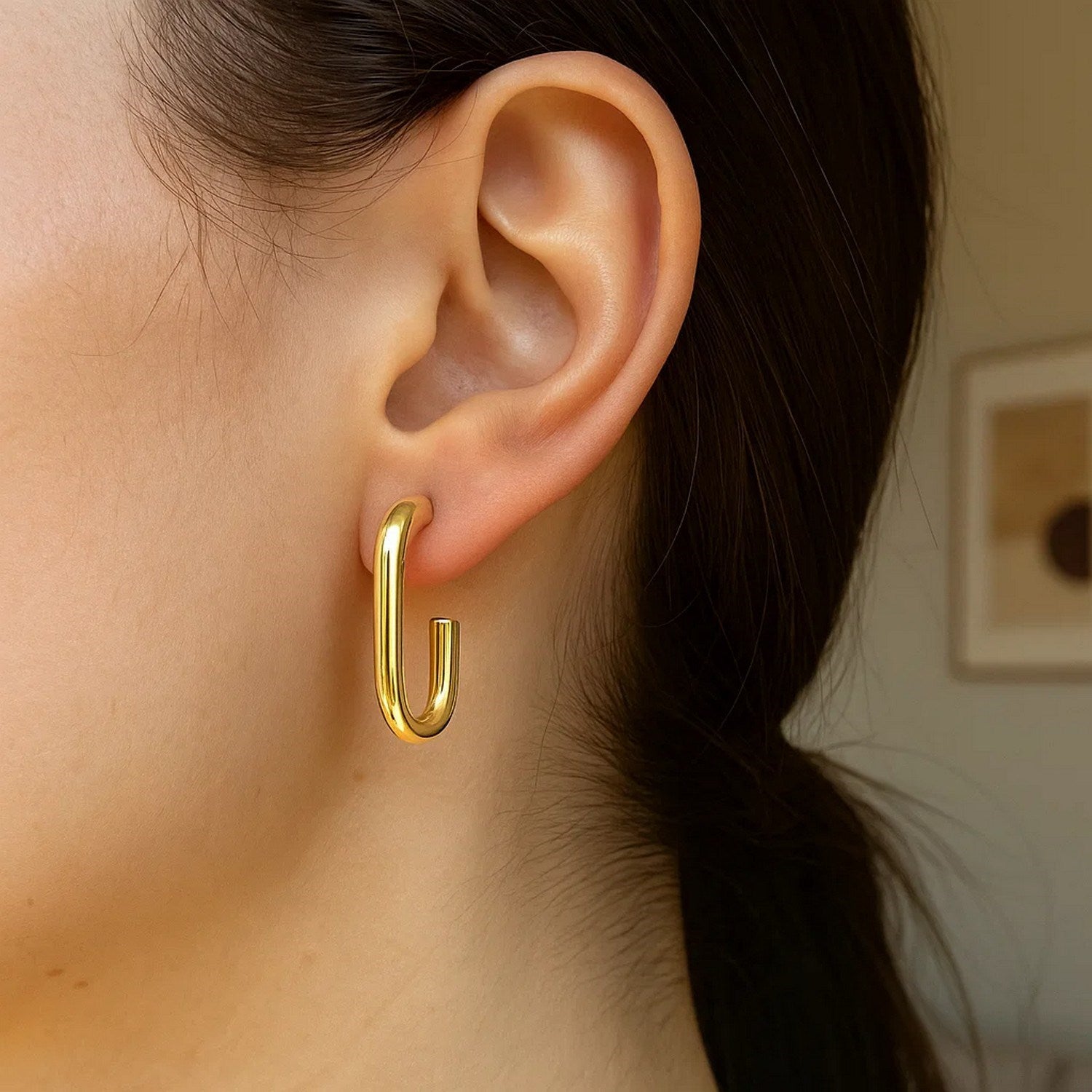 14K yellow gold polished hoop earrings with a sleek modern design, perfect for elegant everyday wear.