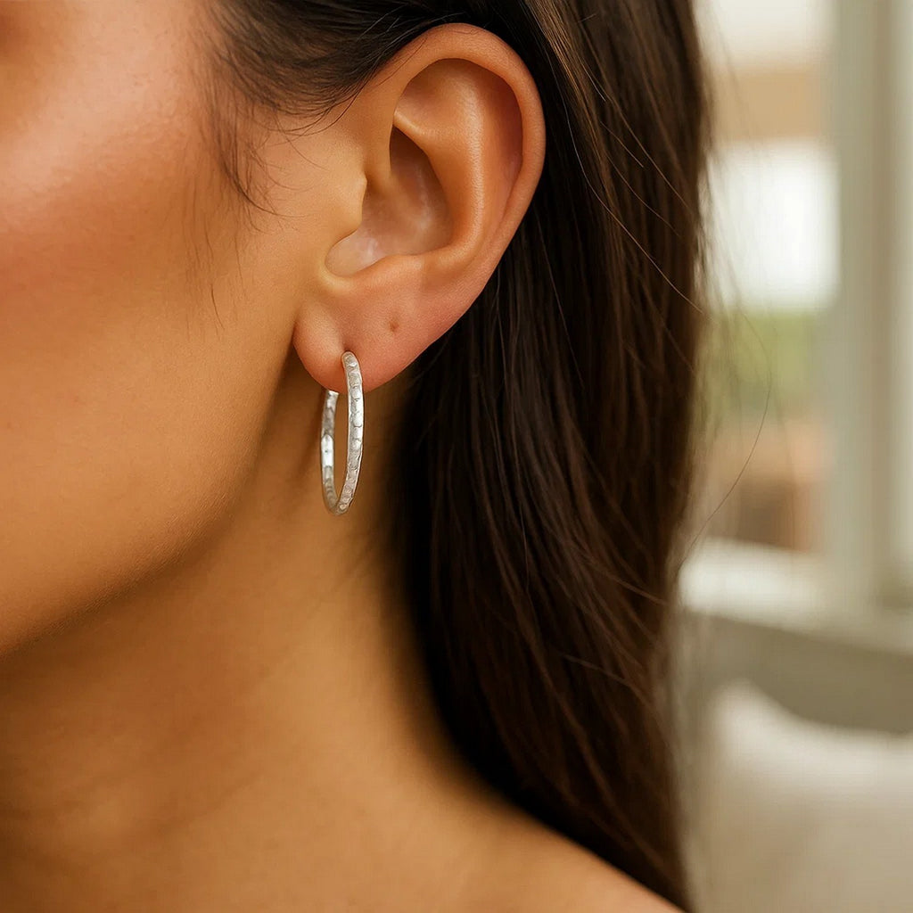 Sterling silver large hoop earrings with a modern hammered texture, perfect for elegant everyday wear.