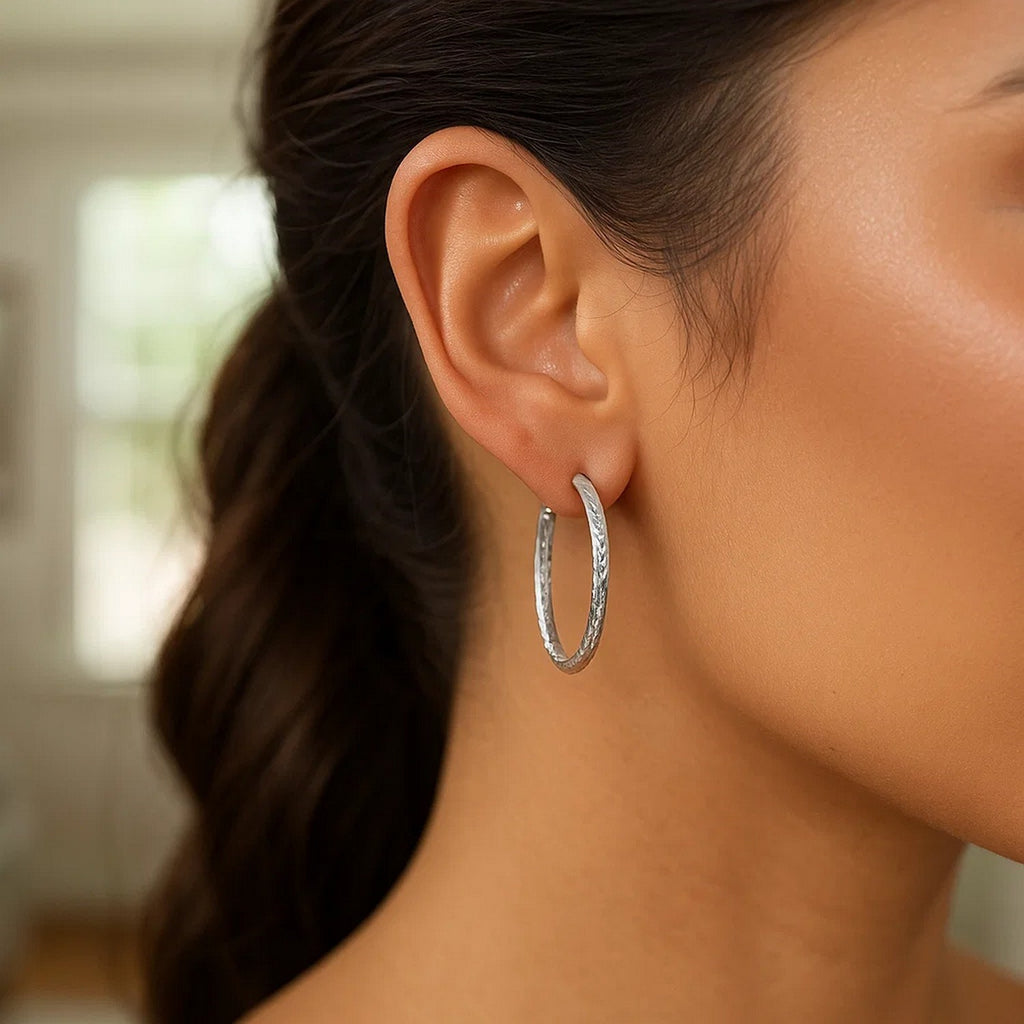 Sterling silver large hoop earrings with a modern hammered texture, perfect for elegant everyday wear.