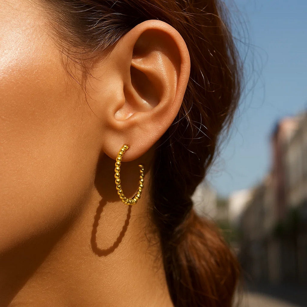 14k yellow gold modern beaded hoop earrings showcasing elegant craftsmanship and timeless design.