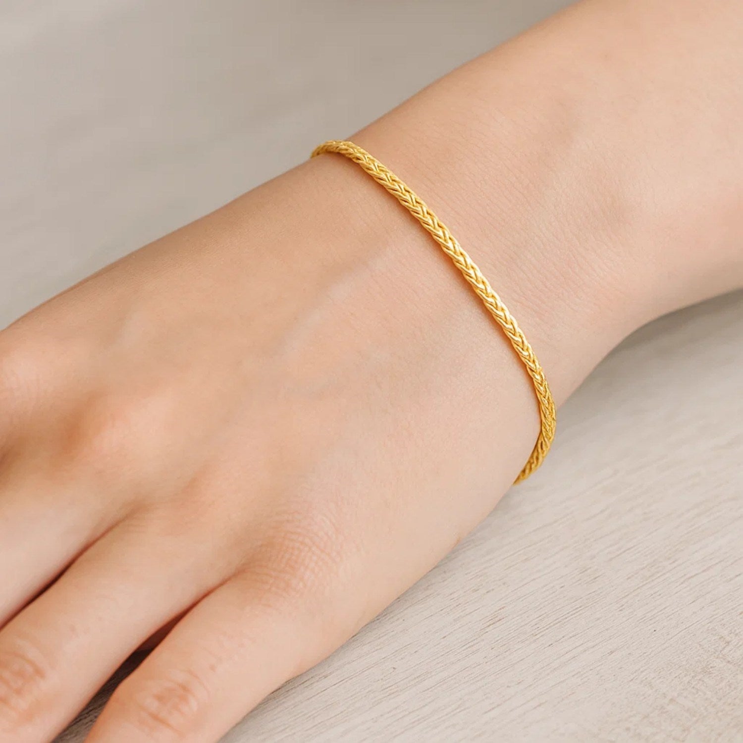 Fine 10k yellow gold wheat chain bracelet with classic design, showcasing luxurious elegance and timeless style.