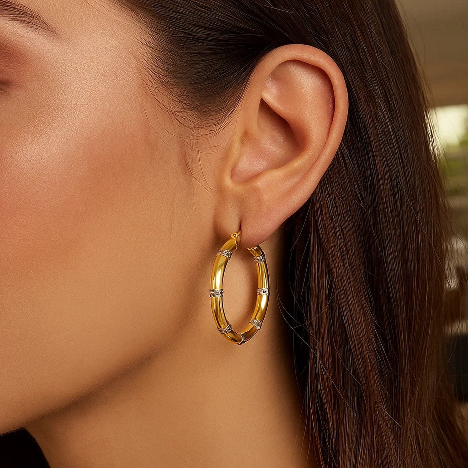 Elegant 14k two-tone gold hoop earrings featuring a textured design and sparkling diamonds for a luxurious touch.