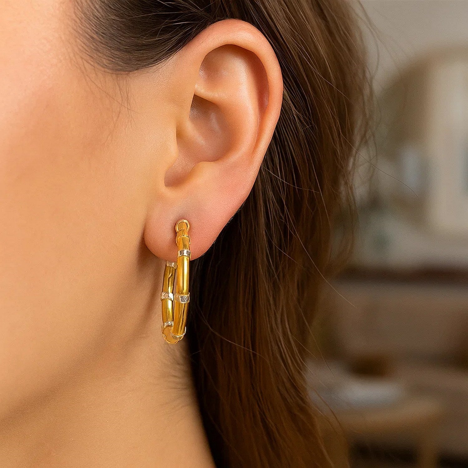 Elegant 14k two-tone gold hoop earrings adorned with sparkling diamonds and a textured finish, perfect for any occasion.