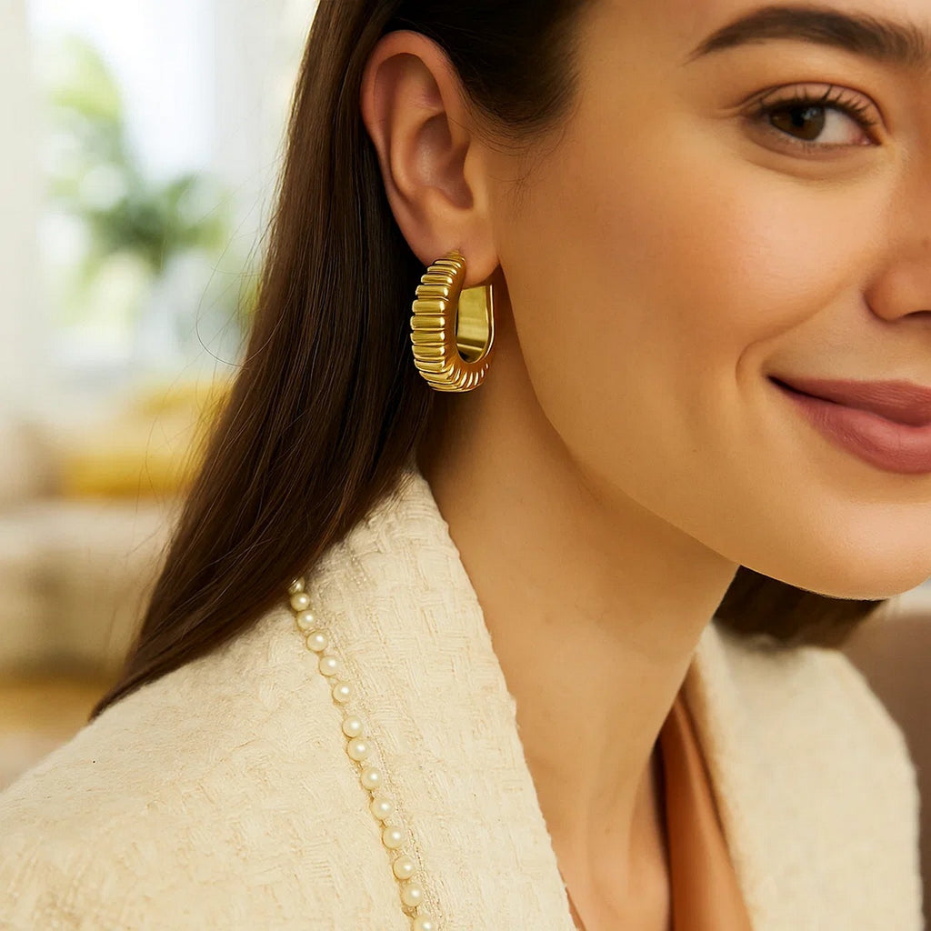 14K yellow gold polished puffed ribbed hoop earrings, exuding elegance and timeless luxury for any occasion.