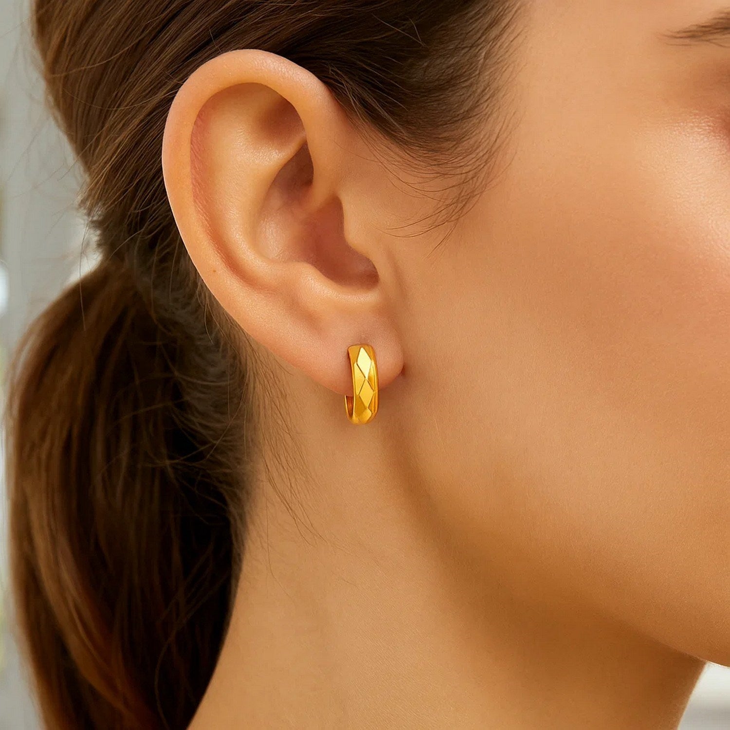 14K yellow gold diamond faceted huggie earrings showcasing modern elegance and exquisite craftsmanship.